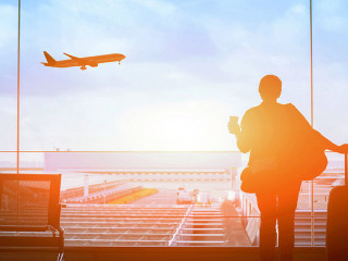 happy traveler waiting for the flight in airport, departure term