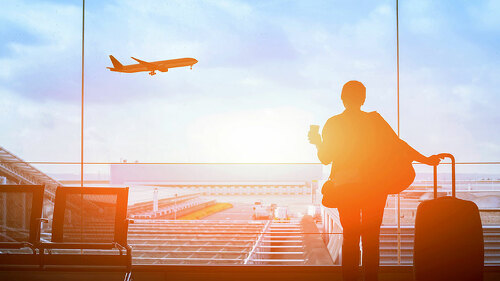 happy traveler waiting for the flight in airport, departure term