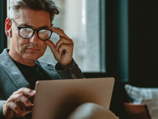 Mature male executive working in office lounge