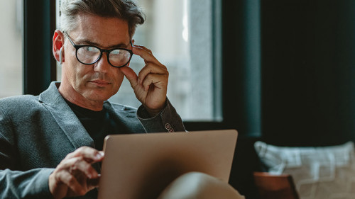 Mature male executive working in office lounge