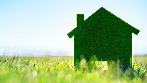 Green ecological house in empty field concept for construction a