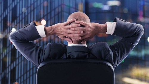 Businessman that relaxes in office and think about the future. double exposure