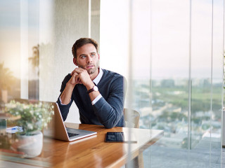 Young entrepreneur deep in thought while working at home