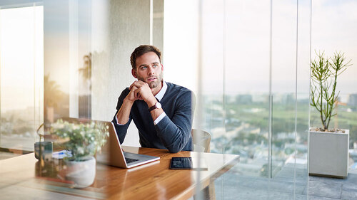 Young entrepreneur deep in thought while working at home