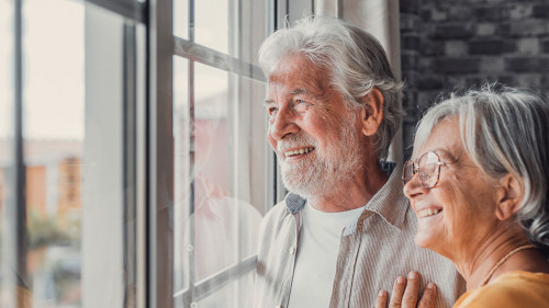 Happy bonding loving middle aged senior retired couple standing