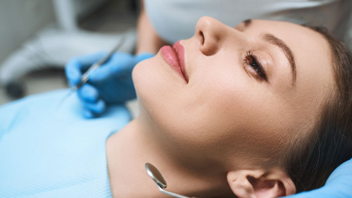 Relaxed young female at dentist stock photo