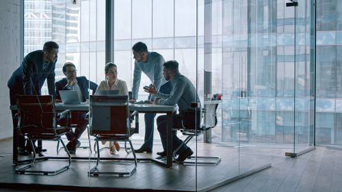 Group of business people working with technology at a meeting in a conference room