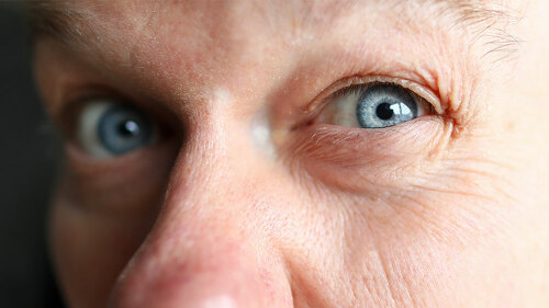 Suspicious male worker trying to see something