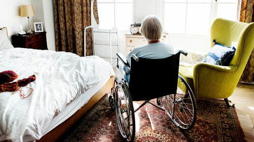 Senior woman sitting on the wheelchair alone