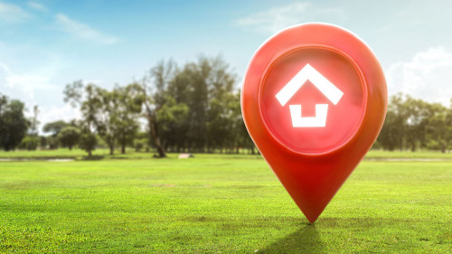 House symbol with location pin icon on earth and green grass in