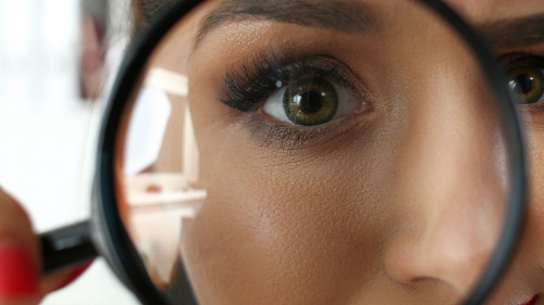 Funny smiling businesswoman hold in arm magnifier