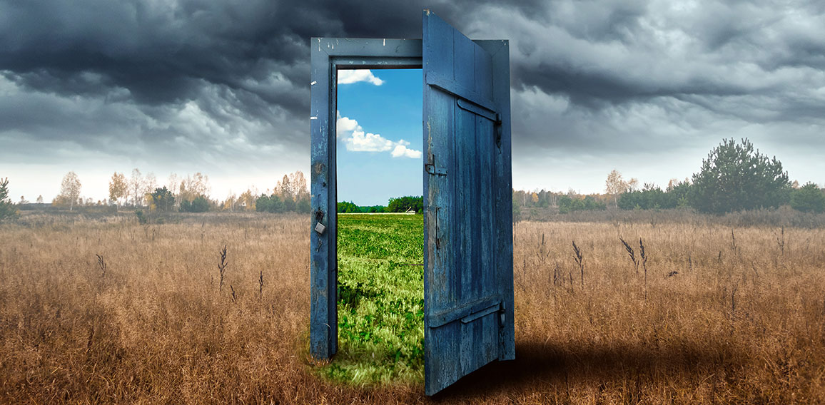 Creative background. Old wooden door, blue color, in the box. Transition to a different climate. The concept of climate change, portal, magic. Copy space.