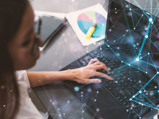 Businesswoman works in office with a laptop with internet effects. Concept of internet sharing and company startup