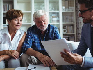 Senior couple planning their investments with financial advisor