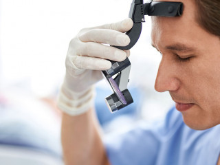 Focused dentist with closed eyes preparing for dental procedure