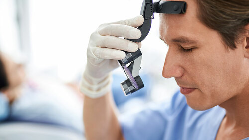 Focused dentist with closed eyes preparing for dental procedure