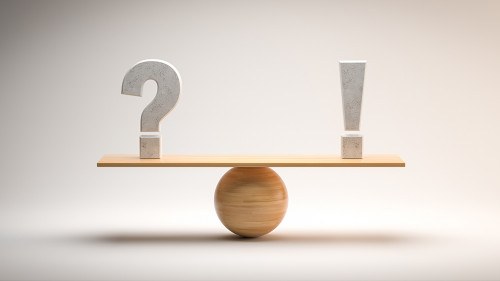 wooden scale balancing a question mark and an exclamation mark o