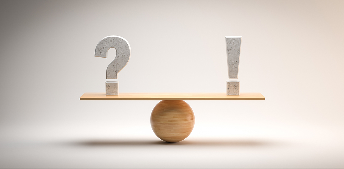 wooden scale balancing a question mark and an exclamation mark o