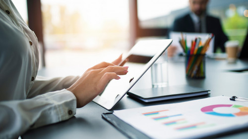 Businesswoman works in office with a tablet.