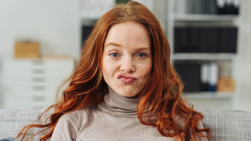 Pretty young redhead woman pulling a face