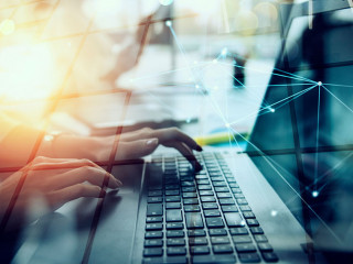 Businesswoman works in office with a laptop with internet effects. Concept of internet sharing and company startup