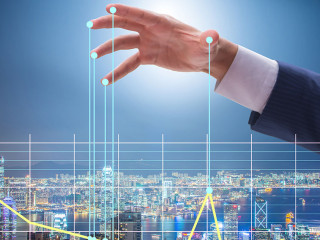 Businessman controlling the market with strings