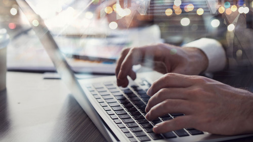 Business man works in office with laptop in the foreground. Concept of teamwork and partnership. double exposure