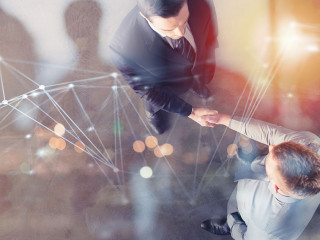 Handshaking business person in office with network effect. concept of teamwork and partnership. double exposure