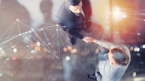 Handshaking business person in office with network effect. concept of teamwork and partnership. double exposure