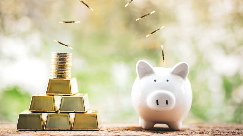 Piggy bank and gold bar with coin drop on the top with working c