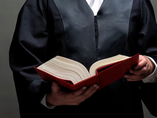 german lawyer with a robe and a book