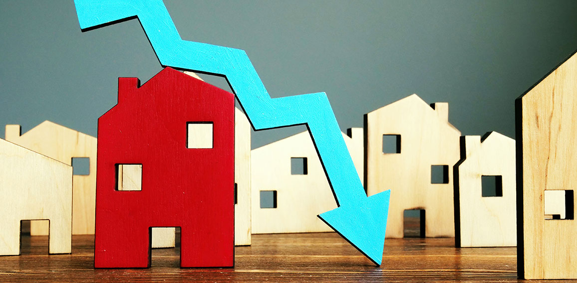 The crisis in the real estate market. Falling home value. Property and downward arrow.