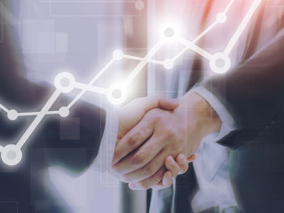 Businessman making handshake with a businesswoman on futuristic