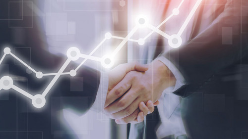 Businessman making handshake with a businesswoman on futuristic