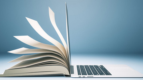 Abstract book and open laptop.