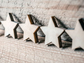 5 Stars Leaning Against A Wooden Wall - Best Quality Concept