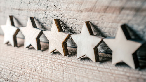 5 Stars Leaning Against A Wooden Wall - Best Quality Concept