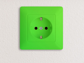 green electrical socket on white wall