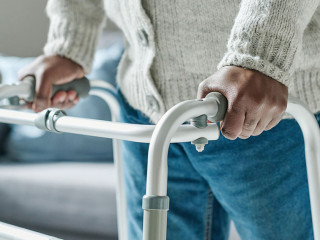 Man walking with walker at home