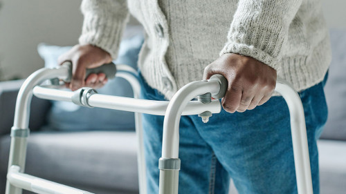 Man walking with walker at home