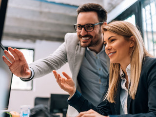 Working together on project. Two young business colleagues worki