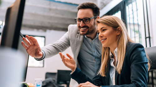 Working together on project. Two young business colleagues worki