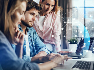 Group of young business people working together on a project. Ne