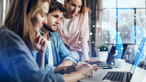 Group of young business people working together on a project. Ne