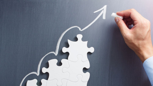 Steps shaped jigsaw puzzle. Drawing arrow on blackboard.