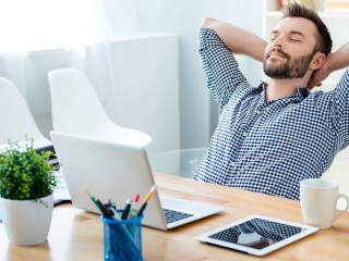 Young worker having break and resting after solving task