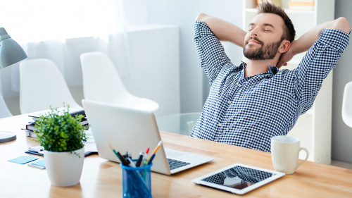 Young worker having break and resting after solving task