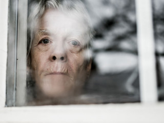 A sad lonely 70 years old senior in is apartment