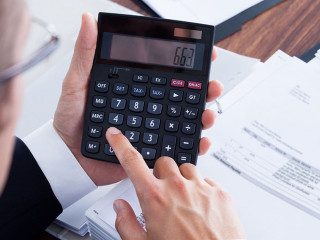 Businessman Using Calculator