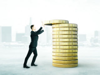 Businessman with coins tower concept
